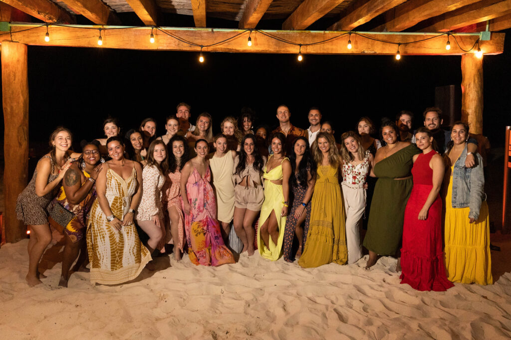 people posing for a group photo on a beacg
